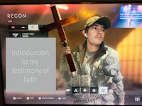 an image of a man holding a cross on a tv screen
